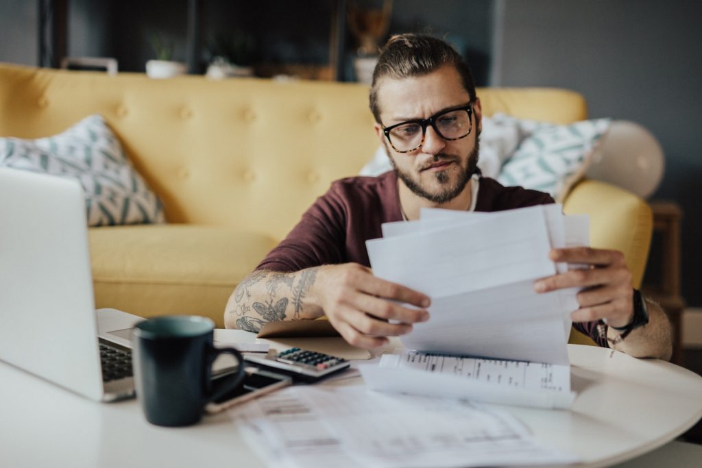 Young man handles household expenses