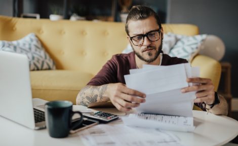 Young man handles household expenses